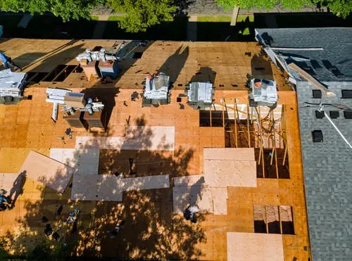 Aerial view of a roof replacement in progress on a Gulf Coast home